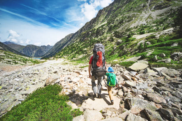 istock Father and son hiking together in mountains 1136371174