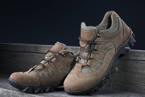 istock Brown sneakers on wooden background. Closeup 1136372722