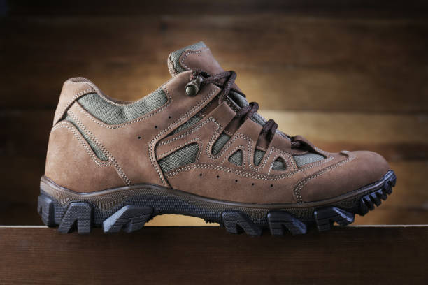istock Hiking boot on wooden background. Closeup 1136372728