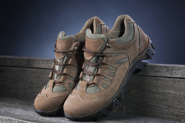 istock Brown sneakers on wooden background. Closeup 1136372729
