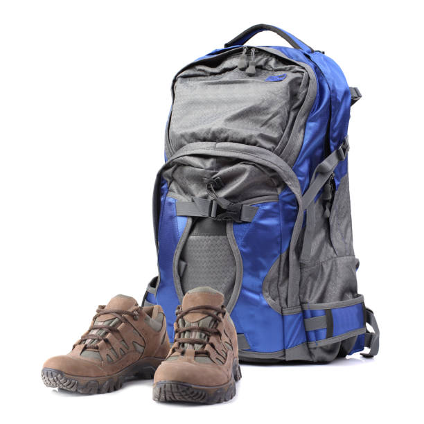 istock Backpack and hiking boots isolated on white background 1136372735