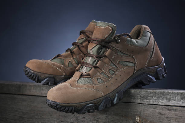 istock Brown sneakers on wooden background. Closeup 1136372741