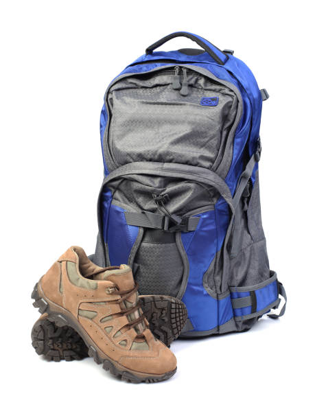 istock Backpack and hiking boots isolated on white background 1136372744
