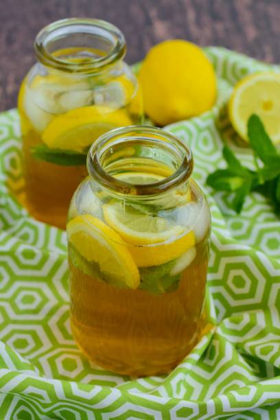 Fresh lemon iced tea with mint leaf in jars