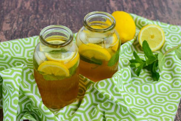 Fresh lemon iced tea with mint leaf in jars