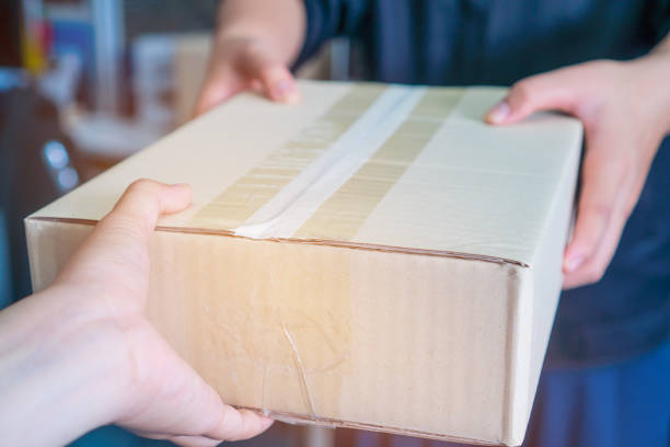 istock Deliveryman get parcel box package to Asian Customer accepting delivery of boxes packages from deliver, Online shopping shipping, ecommerce delivery service concept 1136373947