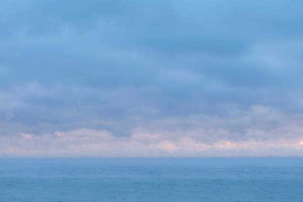 istock Beautiful seascape with pink sunset and blue clouds. 1136374858