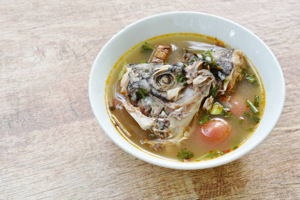istock spicy boiled Tilapia head fish in tom yum soup 1136381900