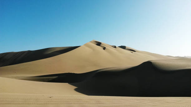 istock Sandunes in Ica, Peru. Sand dunes with shadows on a cloudless hot day 1136382134