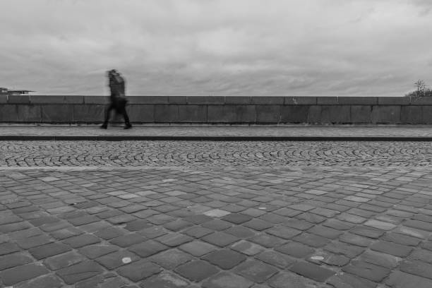 istock Long exposure of a pedestrian walking in the rain 1136383400