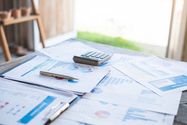istock financial planning working calculating and analyzing financial data at home office Business and office concept. 1136383589