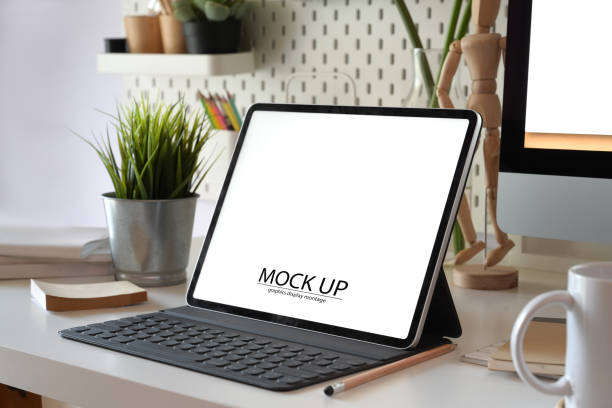 istock office desk table with blank screen tablet, computer keyboard and other office supplies 1136385111