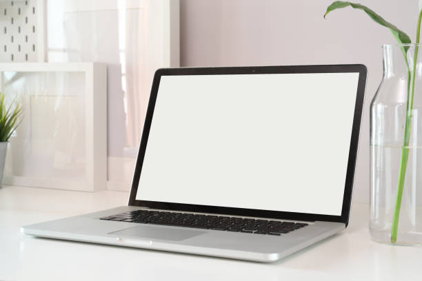 istock Mockup laptop on white wood workspace. 1136385321