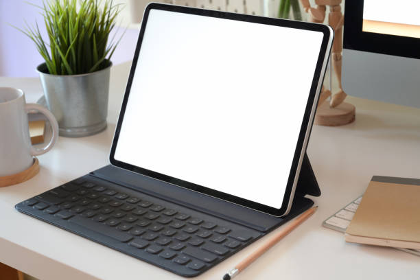 istock office desk table with blank screen tablet, computer keyboard and other office supplies 1136385397