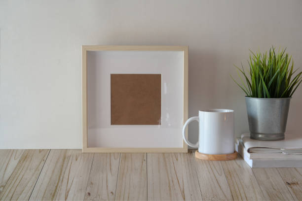 istock Mock up poster or photo frame on wood table 1136385518