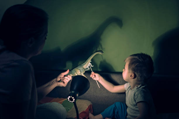 istock Mother and adorable son playing with shadows 1136385644