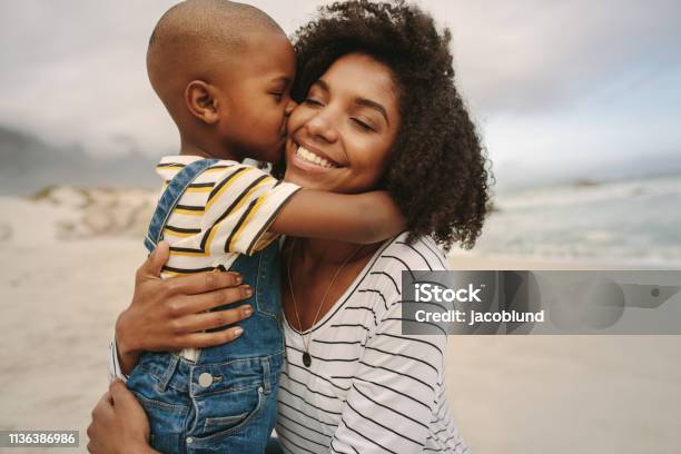 Boy Enjoying At Day Out With His Mother On The Beach Stock Photo - Download Image Now