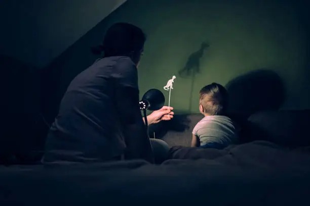 Photo of Mother and little boy playing with shadows