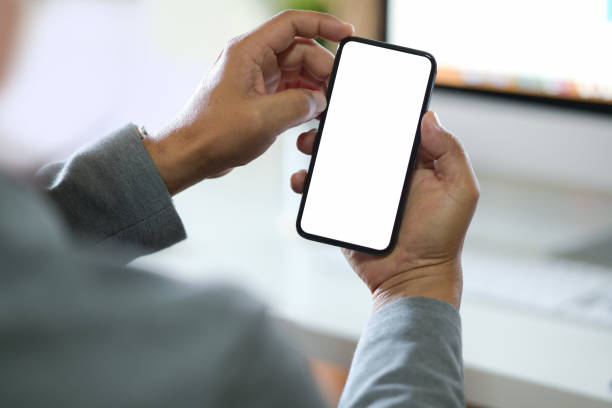 istock Businessman using smartphone. Blank screen mobile phone for graphic display montage. 1136387121