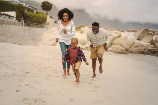 istock Young family enjoying a day at the beach 1136387272