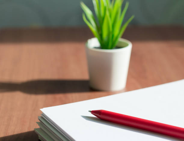istock a stack of white paper and a pen on the office desktop 1136387315