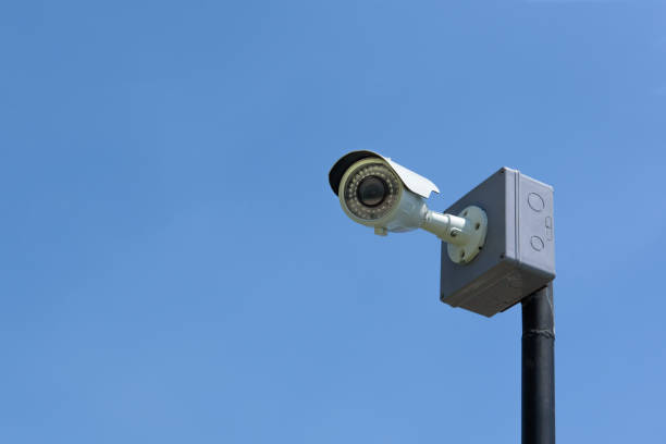 istock CCTV surveillance security camera on a black pole with blue sky background 1136388490