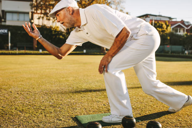 istock Man playing boules in a playground 1136388595