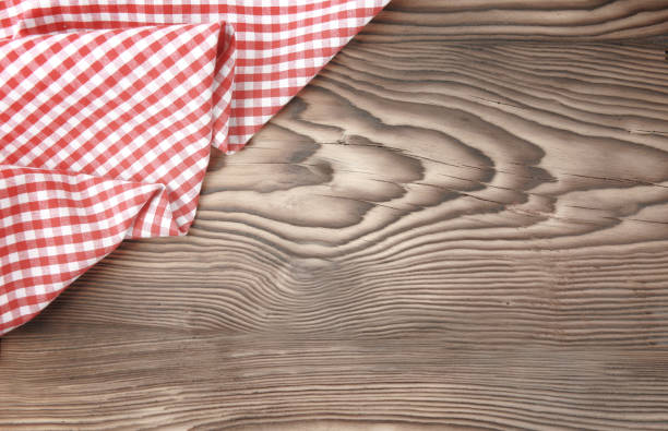 istock Red picnic cloth on wooden background. 1136390239