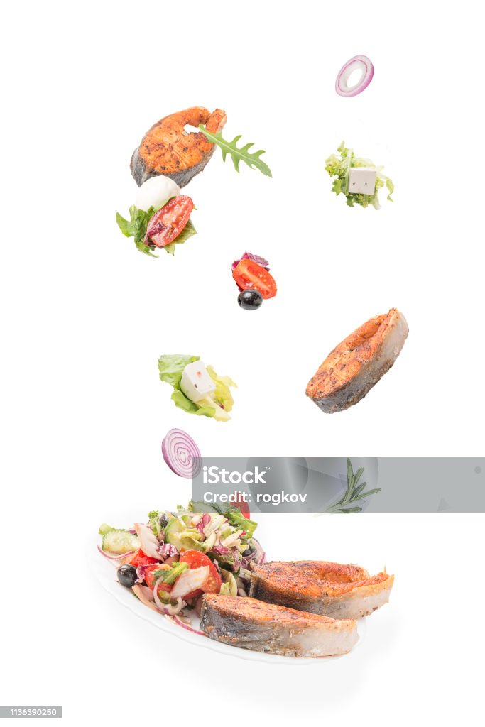 Fish with vegetable salad on white background. Food Stock Photo