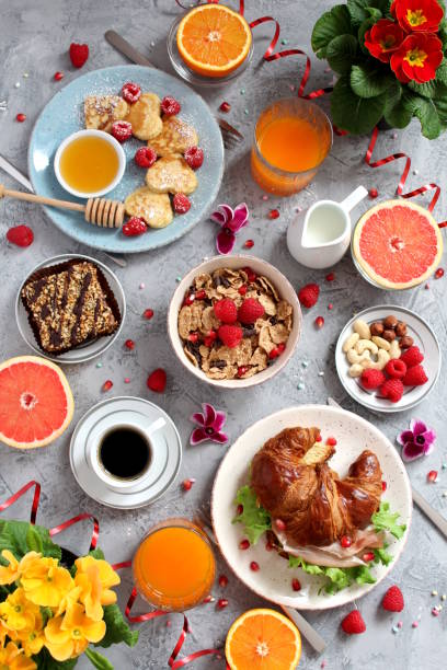 Festive brunch set, meal variety with pancakes, croissants, juice, fresh berries, granola and fresh fruits. Easter breakfast. Breakfast food table. Top view with copy space. bunny pancake stock pictures, royalty-free photos & images