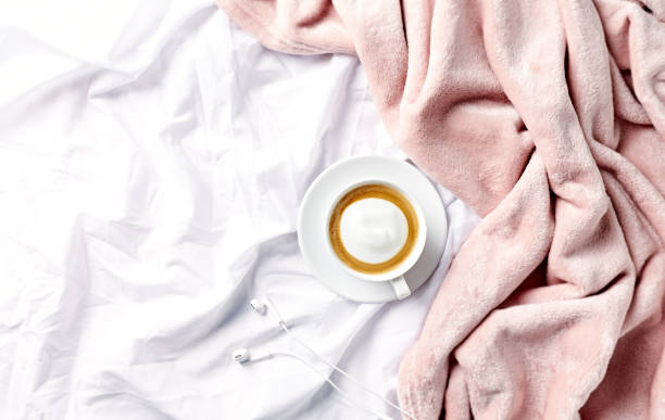 istock A cup of morning coffee in bed. Flat lay. Copy space 1136392076