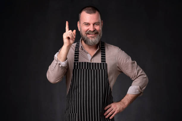 istock Cook provides advice and recommendation, pointing his index finger upwards 1136397296