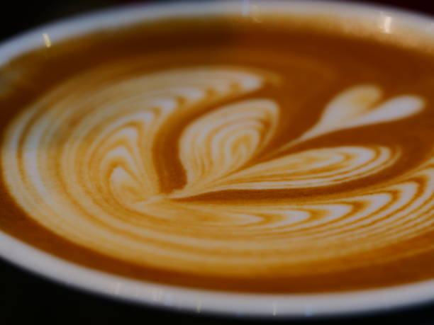 istock Coffee cup with latte art on the wood table 1136397307