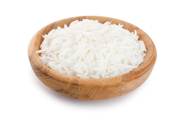 istock rice in a wooden bowl isolated on white background. Top view. Flat lay 1136397670