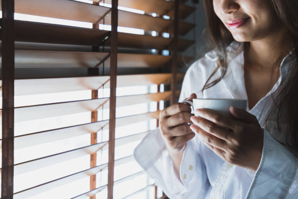istock Asian women hold a white coffee mug 1136397991