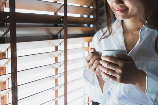 istock Asian women hold a white coffee mug 1136398538