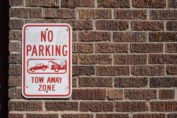 No Parking Sign on a Brick Wall. Tow away zone No Parking Sign on a Brick Wall. Tow away zone no parking sign photos stock pictures, royalty-free photos & images