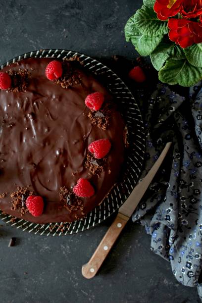istock Chocolate cake with fruits on a plate over dark background. 1136402630