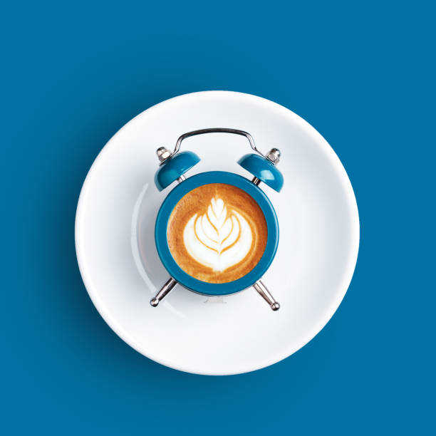 istock Clock with the dial of coffee on blue background. 1136403195