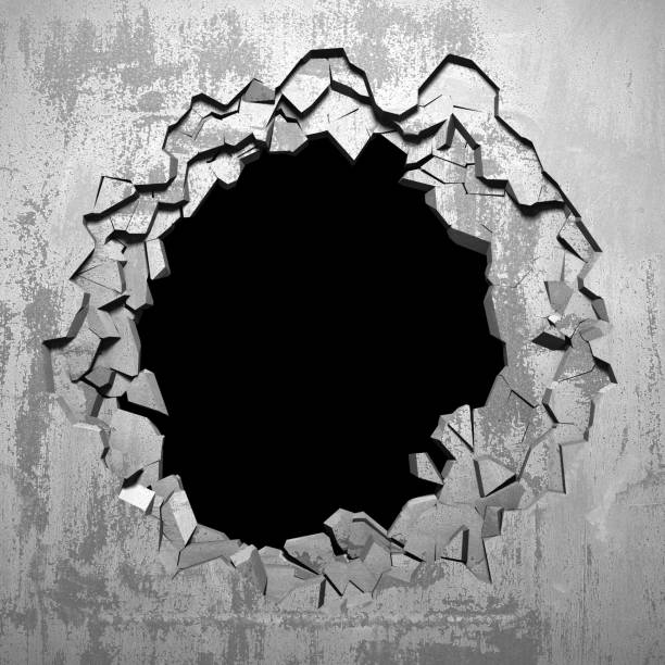 istock Dark cracked broken hole in concrete wall 1136407843