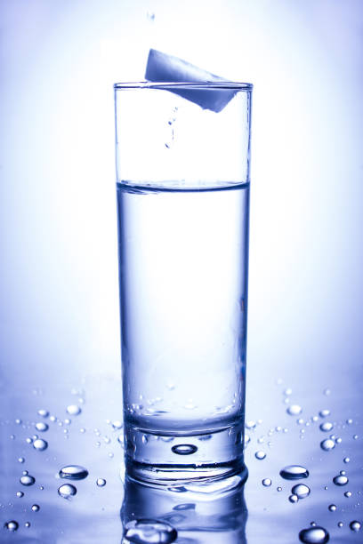 istock Ecology concept. Splash from ice thrown into a glass of clean water 1136408558
