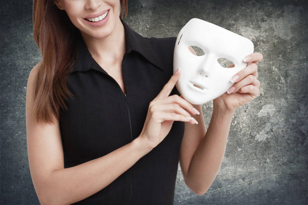 istock Woman holding white mask, double life 1136410234