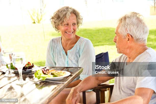 Smiling Senior Couple Enjoying Breakfast In Resort Stock Photo - Download Image Now - 60-64 Years, 70-79 Years, Active Lifestyle