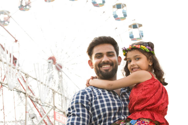 istock Indian father with daughter at amusement park 1136411887
