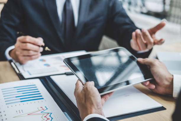 istock Two executive discussing company growth project success financial statistics, Partner meeting professional investor working start up project for both company with document, laptop and digital tablet 1136413098