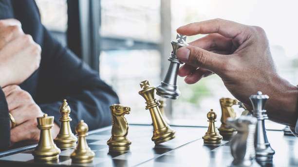 istock Two businessman playing chess game to plan strategy for success, thinking for planning overcoming difficulty and achieving goals business strategy for win 1136413107