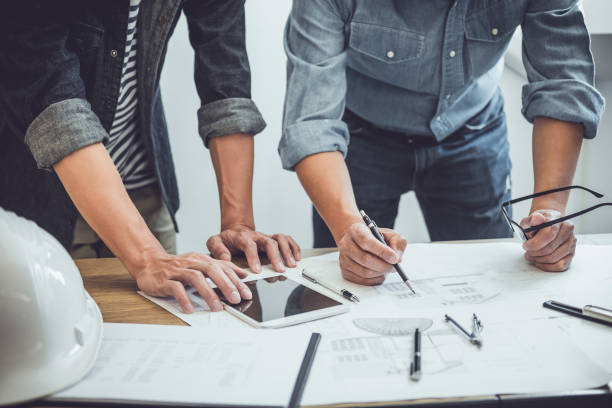istock Engineer Teamwork Meeting, Drawing working on blueprint meeting for project working with partner on model building and engineering tools in working site, Construction and structure concept 1136413111