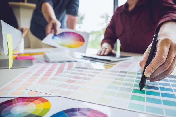 istock Two colleagues creative graphic designer working on color selection and drawing on graphics tablet at workplace 1136413123