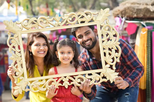 Happy Indian family posing in a picture frame