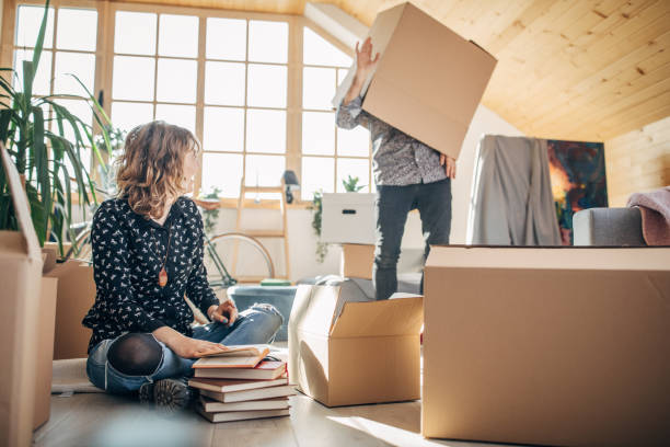 istock Playful couple moving in into new home 1136415244
